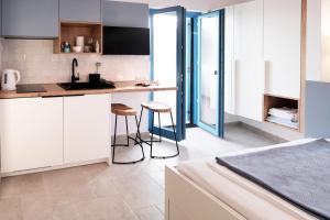 a kitchen with a counter and stools in a room at House Mateja Unije in Unije