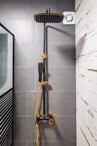 a shower with a hair dryer in a bathroom at Modern studio D-va N in Zalău