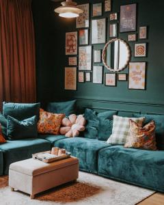sala de estar con sofá azul y espejo en The Greeen Room, en Launceston