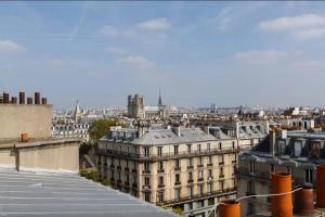 a view of a city from the roof of a building at Private room center Paris in Paris
