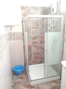 a shower with a glass door in a bathroom at 2 bedroom entire Apt Fully air conditioned-MSA City centre in Mombasa