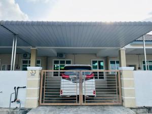 a white van parked in front of a house at FATEHA HOMESTAY PENDANG in Pendang