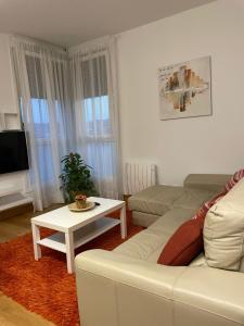 a living room with a white couch and a table at MODERN BILBAO in Barakaldo
