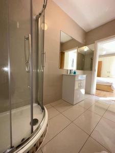a large bathroom with a shower and a sink at Coastal Dublin, 4 adult bed spaces+child max in Dublin