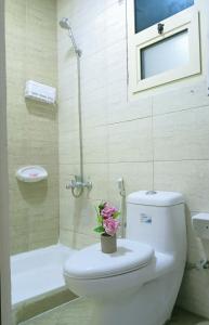 a bathroom with a toilet with a flower on it at Large Studio Room In-Al khalidiya Abudhabi in Abu Dhabi