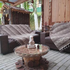 patio z kanapami i stołem na patio w obiekcie Sitio do Sol quarto wc compartilhado w mieście Guabiruba