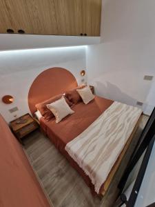 - une chambre avec un grand lit et une tête de lit en bois dans l'établissement Ossidiana Rossa Elegant Suite Vulcano, à Vulcano