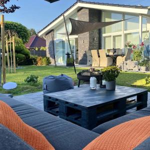 a coffee table on a patio with two chairs at Idylisches Ferienhaus in Edewecht