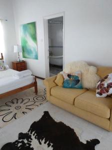a living room with a couch and a bed at Selen's Apartment in Ti Rocher Micoud Saint Lucia in Micoud