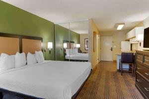 a hotel room with a large bed and a bathroom at Extended Stay America Suites - San Jose - Downtown in San Jose