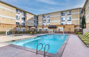 a swimming pool in front of a apartment building at Extended Stay America Premier Suites - San Jose - Airport in San Jose