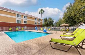 a swimming pool with lounge chairs and a hotel at Extended Stay America Suites - Phoenix - Scottsdale in Scottsdale