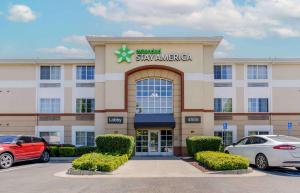 Un hotel con coches aparcados delante. en Extended Stay America Suites - Pleasanton - Chabot Dr, en Pleasanton