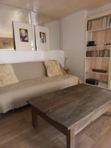 a living room with a couch and a wooden table at Le Nid in Avignon