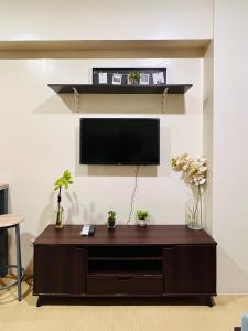 a living room with a flat screen tv on a wall at * *Q Incomparable Comfort for 3 in Iloilo City