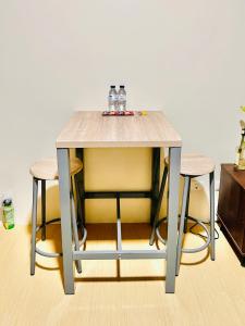 a table with three glasses on top of it with two stools at * *Q Incomparable Comfort for 3 in Iloilo City