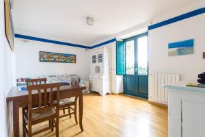 a kitchen with a table and chairs in a room at Trapani Egadistar Apartments in Trapani