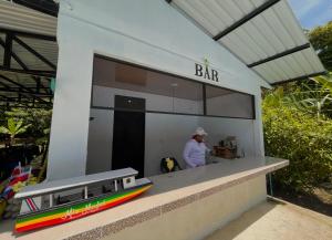 a model train station with a man standing in it at Los Amigos Jungle Hotel Tortuguero in Tortuguero