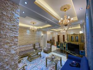 a living room with a couch and a tv at LuXury Apartment Agouza-Mohandesin in Cairo