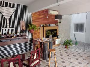 a room with a table and chairs and a fireplace at Pousada VIDA in Pelotas