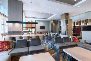 a hotel lobby with couches and a bar at Residence Inn by Marriott Tempe Downtown/University in Tempe