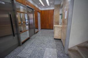 a hallway of an office building with elevators and doors at Beach House 2 in Guarujá