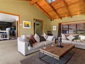 a living room with a couch and a coffee table at The Terrace Lake Tarawera in Lake Tarawera