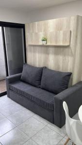 a couch sitting in a living room with a table at Departamento céntrico-46 n 326 entre1y2 in La Plata