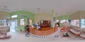 a group of people walking around a room with a counter at Siona Hotel in Atacames