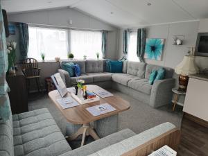 a living room with a couch and a table at Haven Rockley Park, Lytchett Bay View, Private Holiday Home - Caravan in Lytchett Minster