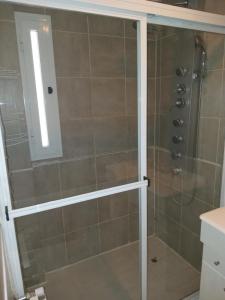 a bathroom with a shower with a glass door at Rukan in Comodoro Rivadavia