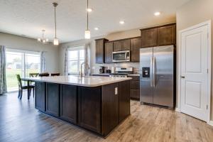 a kitchen with wooden cabinets and a stainless steel refrigerator at Cozy Cartersburg Home about 14 Mi to Indianapolis 