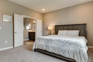 a bedroom with a large bed and a bathroom at Cozy Cartersburg Home about 14 Mi to Indianapolis 