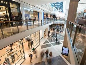 a group of people walking around a shopping mall at Luxury 2Beds Apt with stunning View (Parking, Gym) in Sydney