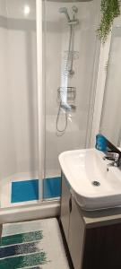 a bathroom with a shower and a white sink at Haven Rockley Park, Lytchett Bay View, Private Holiday Home - Caravan in Lytchett Minster
