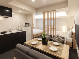 a kitchen and living room with a table and a couch at MIMARU TOKYO UENO EAST in Tokyo