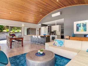 a living room and kitchen with a couch and a table at FlaxWater Lake Tarawera in Lake Tarawera