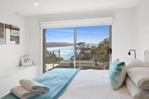 a bedroom with a view of the ocean at Scelta in Lorne