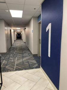 a hallway with a blue door with a number on it at Holiday Inn Express Hotel & Suites Hiawassee, an IHG Hotel in Hiawassee