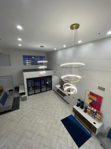 a large living room with a fireplace and chandelier at Holiday Inn Express Hotel & Suites Hiawassee, an IHG Hotel in Hiawassee