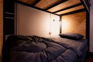 Postel nebo postele na pokoji v ubytování ANOU HOSTEL
