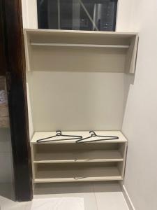 a white closet with two hangers in it at Origem in Mamanguape