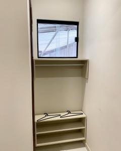 a mirror in a room with shelves and a window at Origem in Mamanguape
