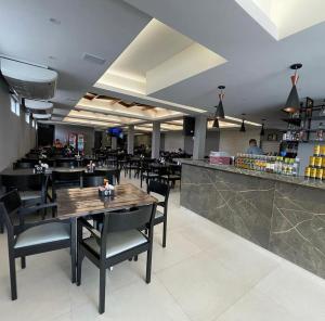 a restaurant with a table and chairs and a counter at Origem in Mamanguape