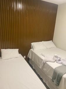 two beds sitting next to each other in a room at Origem in Mamanguape