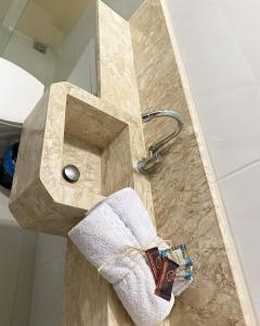 een badkamer met een marmeren wastafel en een handdoek bij Origem in Mamanguape