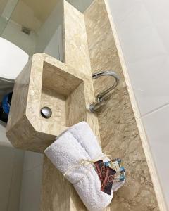 a bathroom with a marble sink with a towel at Origem in Mamanguape