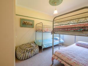 a bedroom with two bunk beds in it at Woodview Cottage Farm stay in Port Welshpool