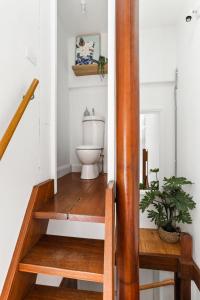 a bathroom with a toilet on a wooden staircase at Stylish Darlinghurst Townhouse l 3 Bedrooms in Sydney