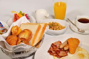 a table with a plate of breakfast foods and a cup of coffee at Hilton Zhoushan in Zhoushan